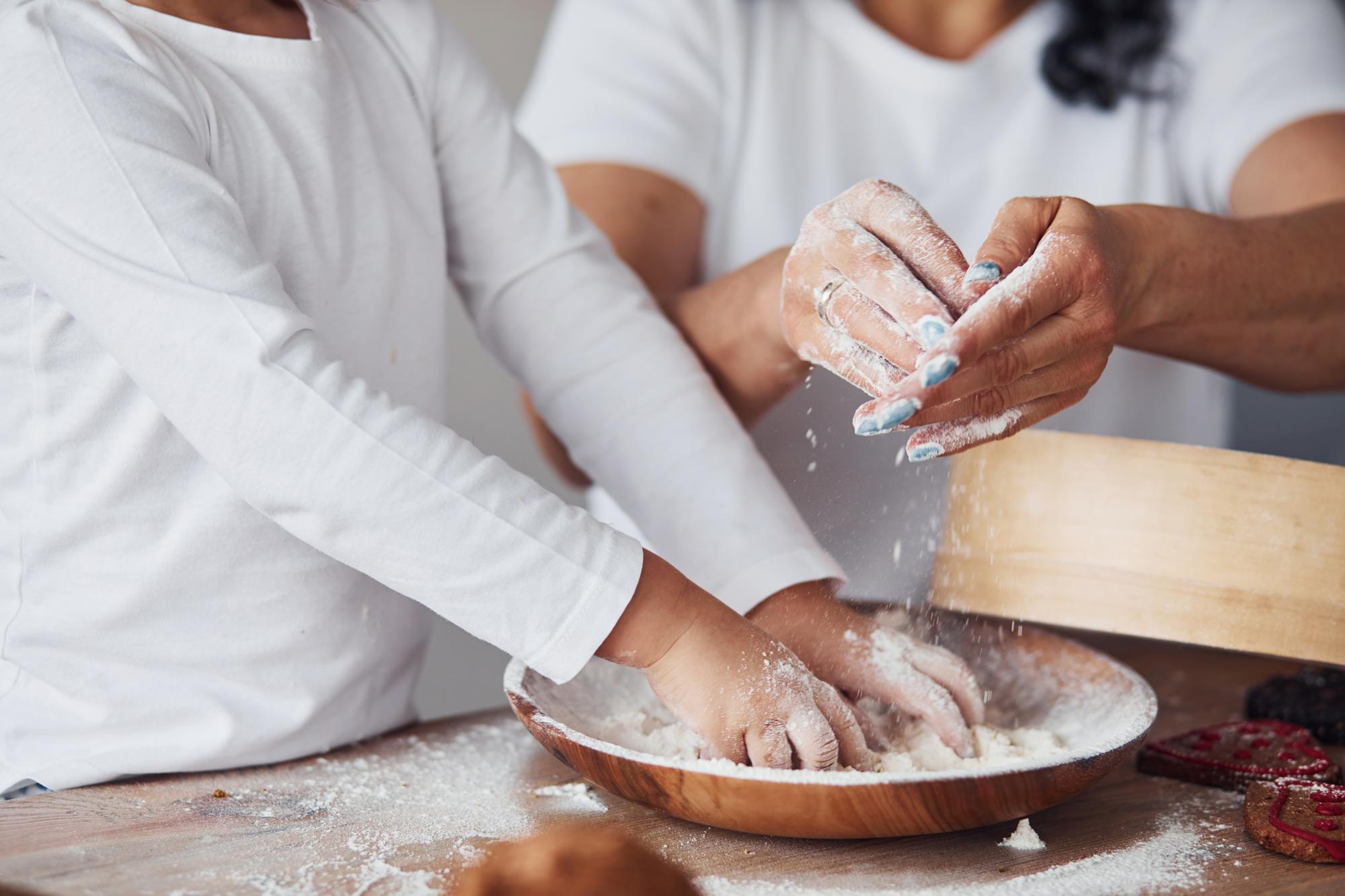 Workshop participants kneading dough around a large table