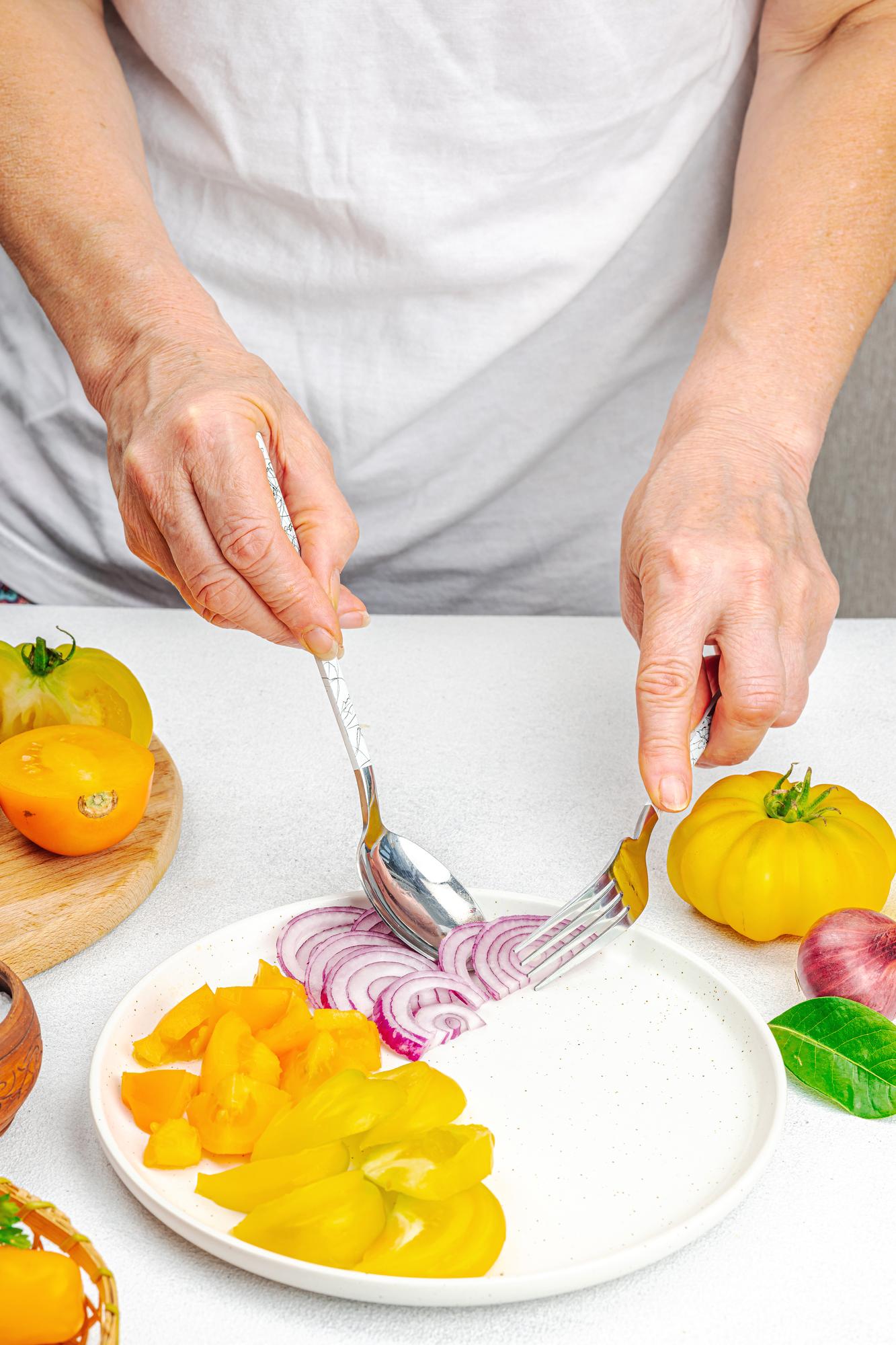 Chef preparing a colorful plated dish in a bright kitchen